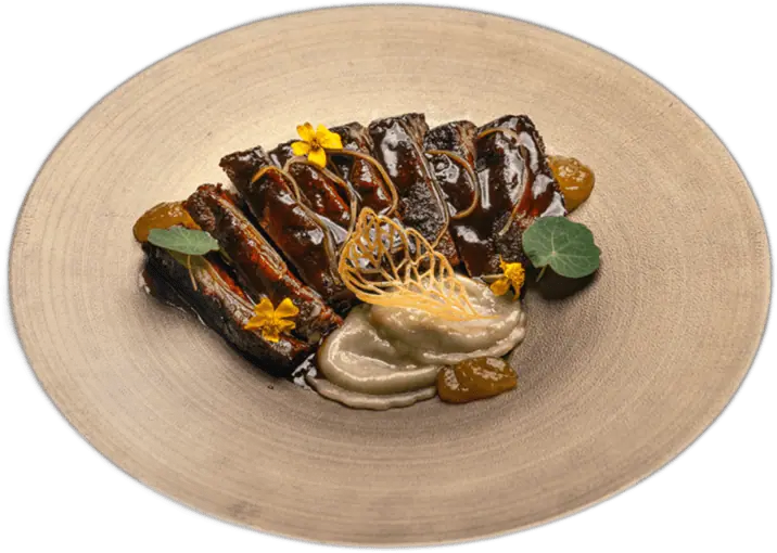 Glazed short ribs on a sand-coloured plate